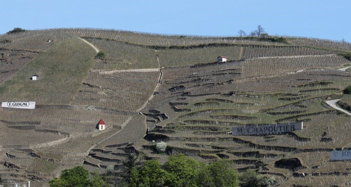 You always know you're looking at the the sweet spot of the famed slope of Côte Brune by the small red roofed <em>pavillon</em> now owned by René Rostaing. The Guigal mural at far left marks La Turque while the larger <em>pavillon</em> at top marks the holdings of Domaine Barge.